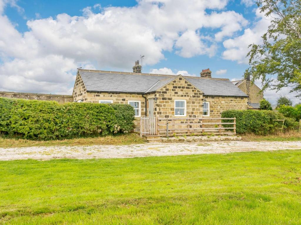 a stone house with a yard in front of it at 1 Bed in Pateley Bridge 89152 in Summer Bridge