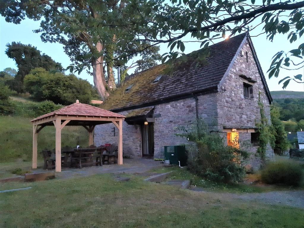 an old stone building with a gazebo at 2 Bed in Crickhowell 42920 in Llangattock