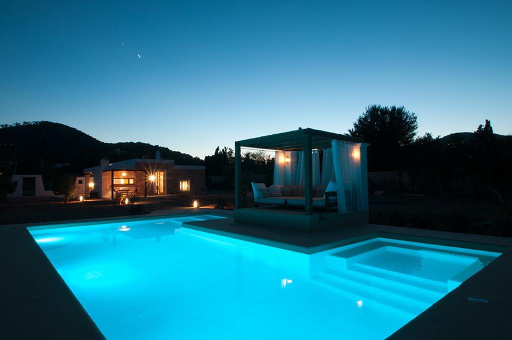 a swimming pool at night with a gazebo at Ibiza Holliday Villa Harmony in Sant Jordi