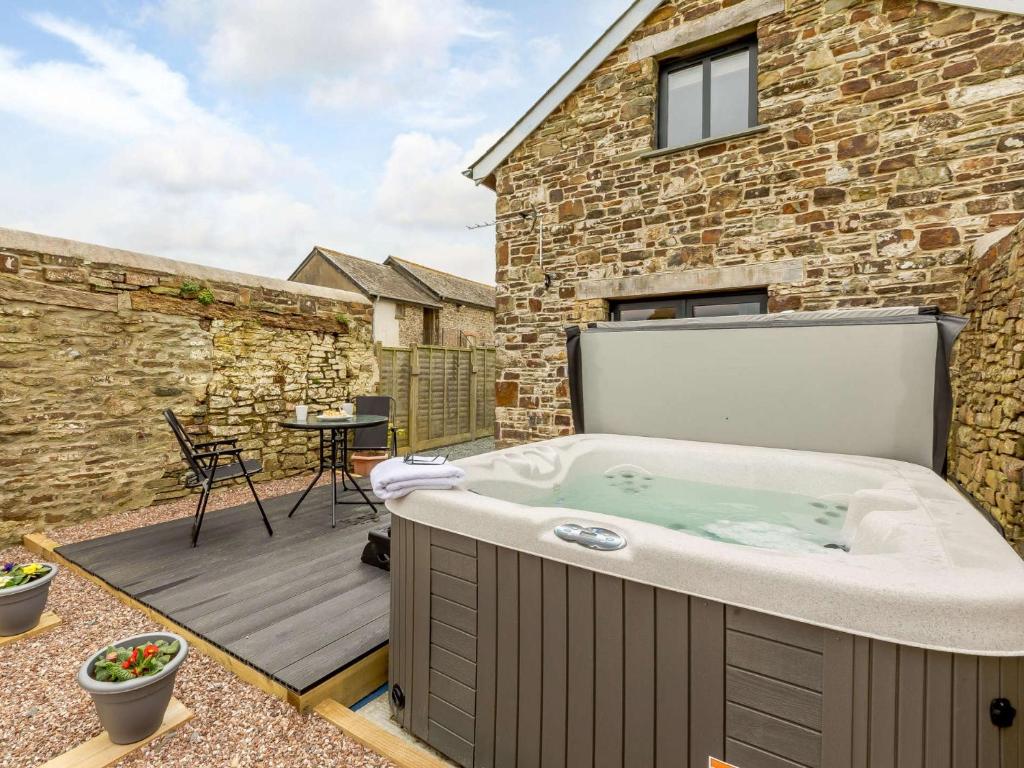 a hot tub on the deck of a house at 2 Bed in Umberleigh 54354 in Atherington