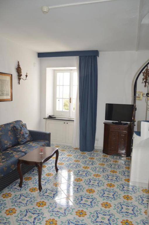 uma sala de estar com um sofá e uma mesa em SEI A CAPRI em Capri