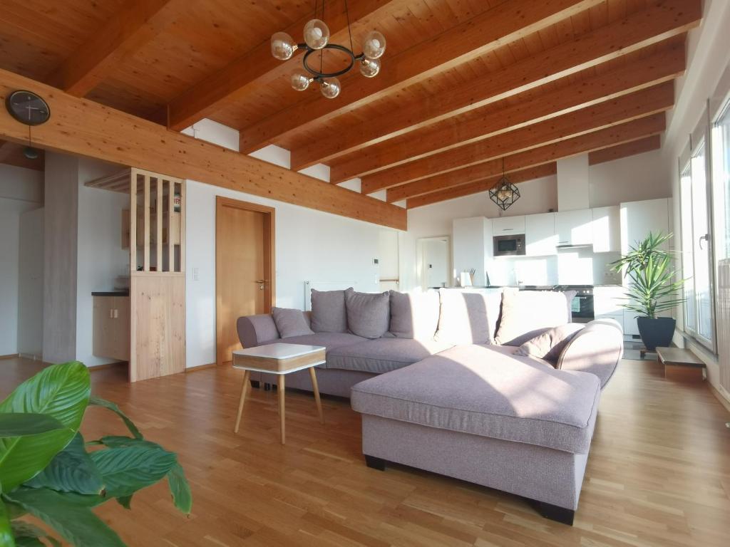 a living room with a couch and a table at BeeHome Apartment in Purkersdorf