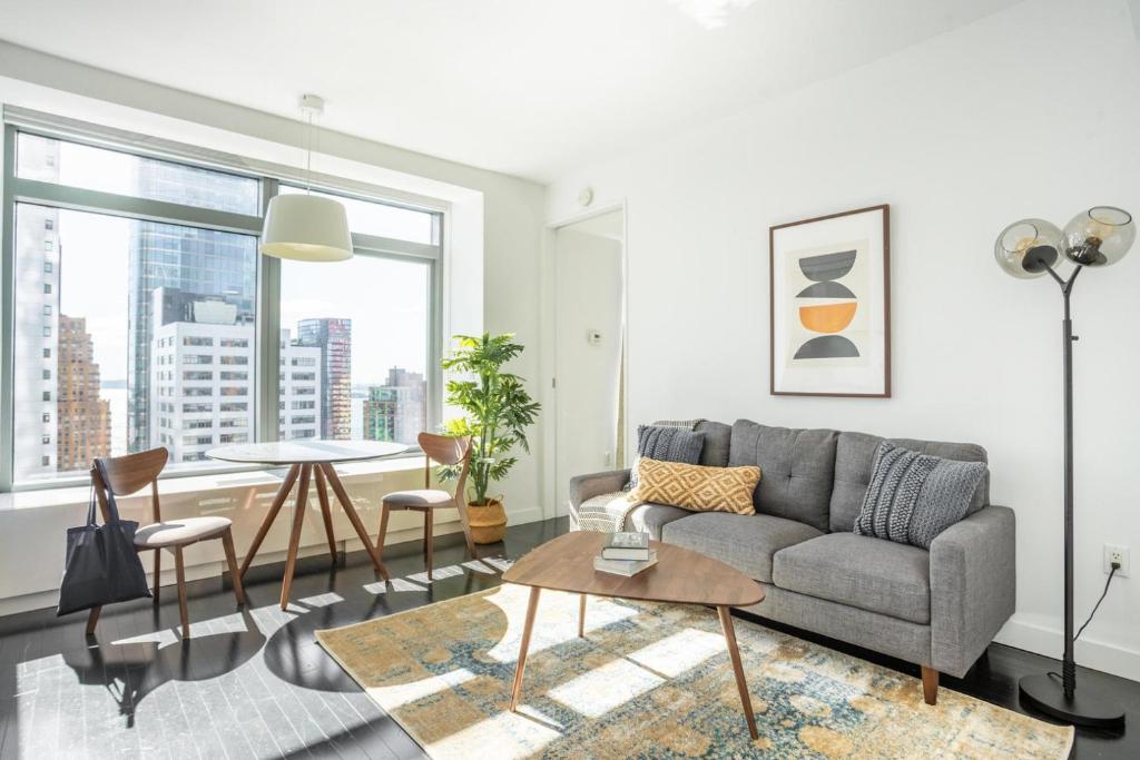 - un salon avec un canapé et une table dans l'établissement Financial District 1br w WD gym elevator NYC-1362, à New York