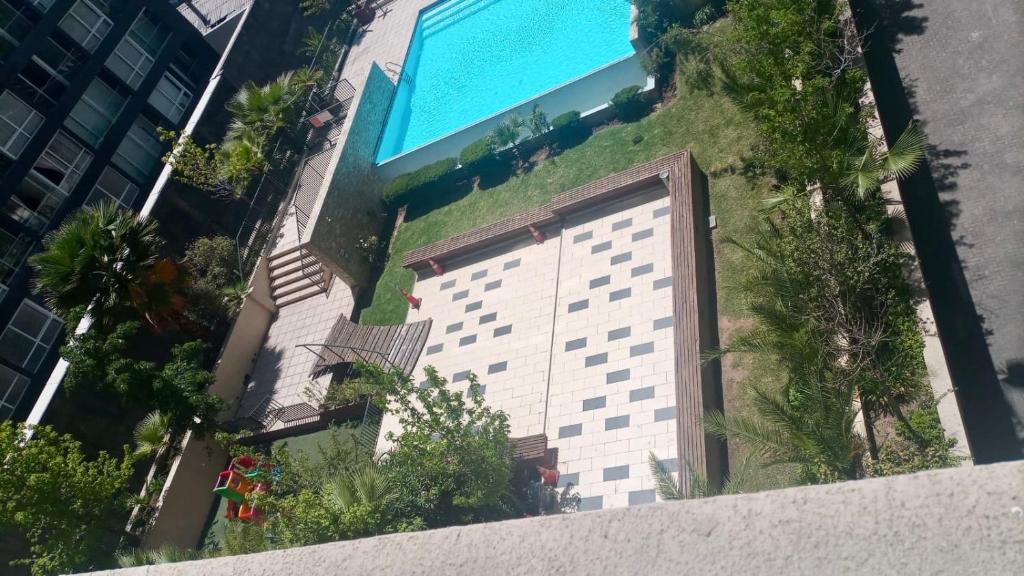 an overhead view of a building with a swimming pool at Departamento Central Santiago in Santiago