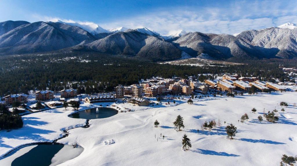 an aerial view of a resort in the snow at Pirin Golf & Country Club Apartment Complex in Bansko