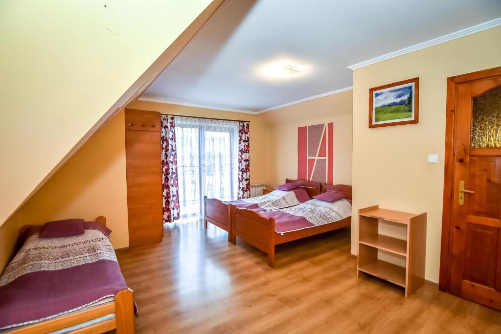 Postel nebo postele na pokoji v ubytování Cudzichówka