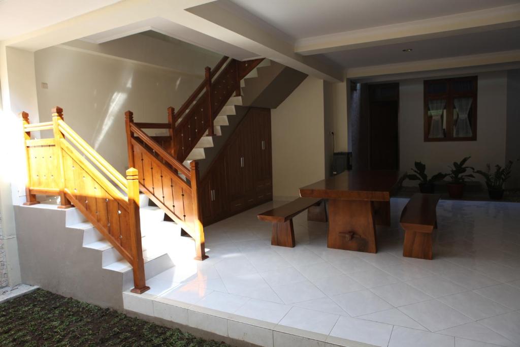 a staircase in a house with a bench and a table at Griya Hanna in Yogyakarta
