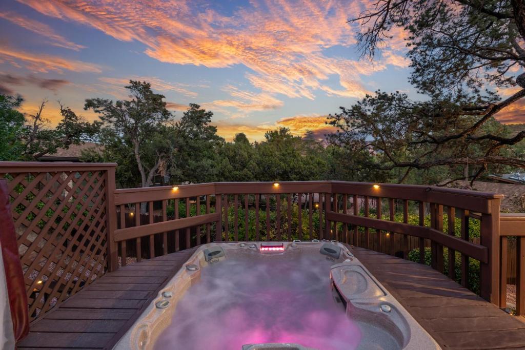 a hot tub on a deck with a sunset at Large Spanish Villa -Hot tub- Pool -Gym- Game Room in Sedona
