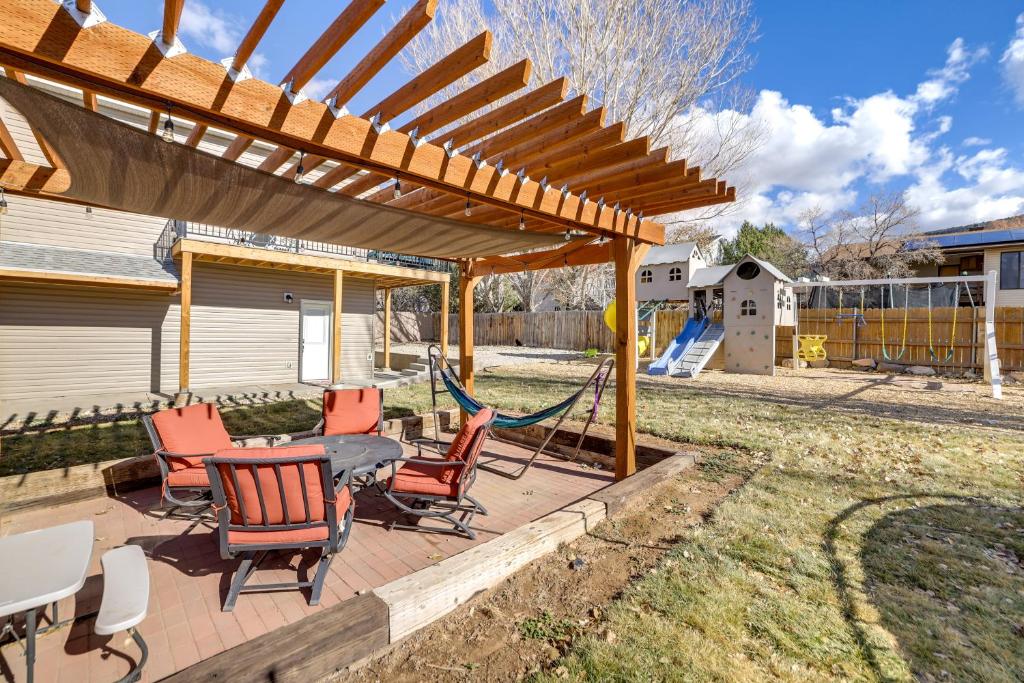 a patio with chairs and a hammock under a pergola at Cedar City Apartment about 3 Mi to Downtown! in Cedar City