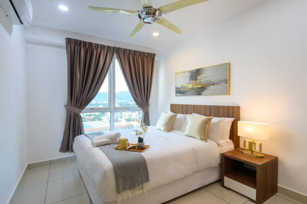 a bedroom with a large bed and a window at Deluxe Studio/Gurney/Mansion One in George Town