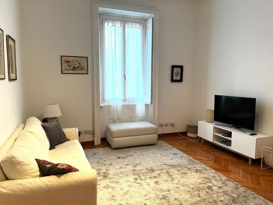 a living room with a couch and a television at Elegante appartamento in centro in Milan