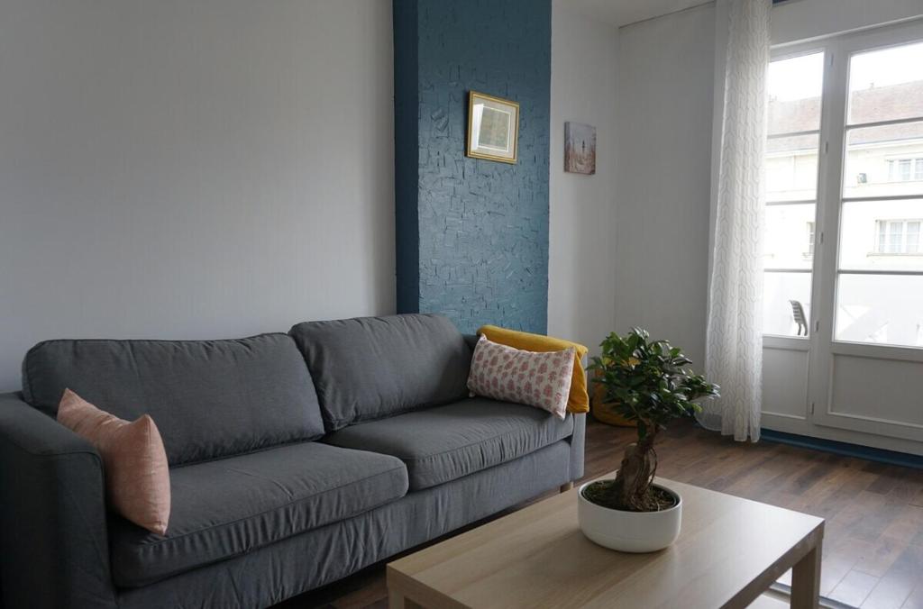 a living room with a couch and a table at 3 Bedrooms - Spacious and friendly - City Center in Caen