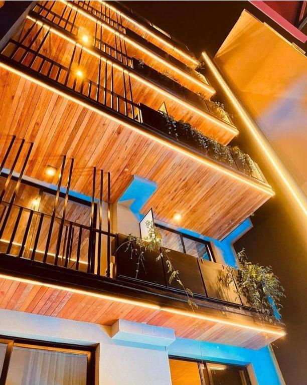a building with a balcony with plants on it at ANDÉN by FMA Coliving in Salta