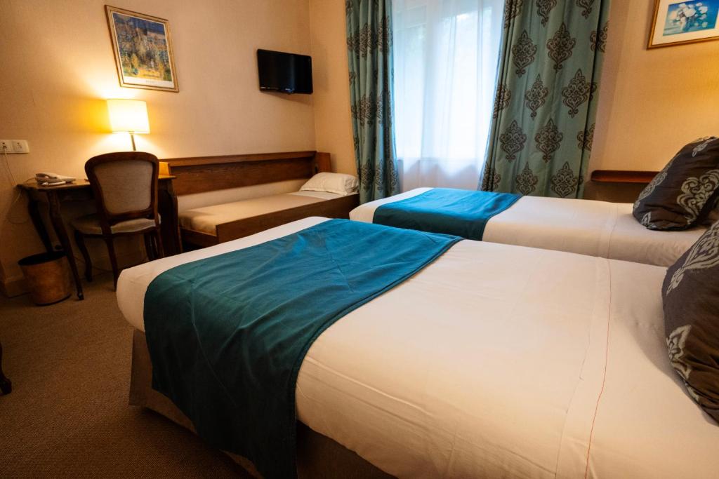 Postel nebo postele na pokoji v ubytování Cit'Hotel Sphinx - Hotel