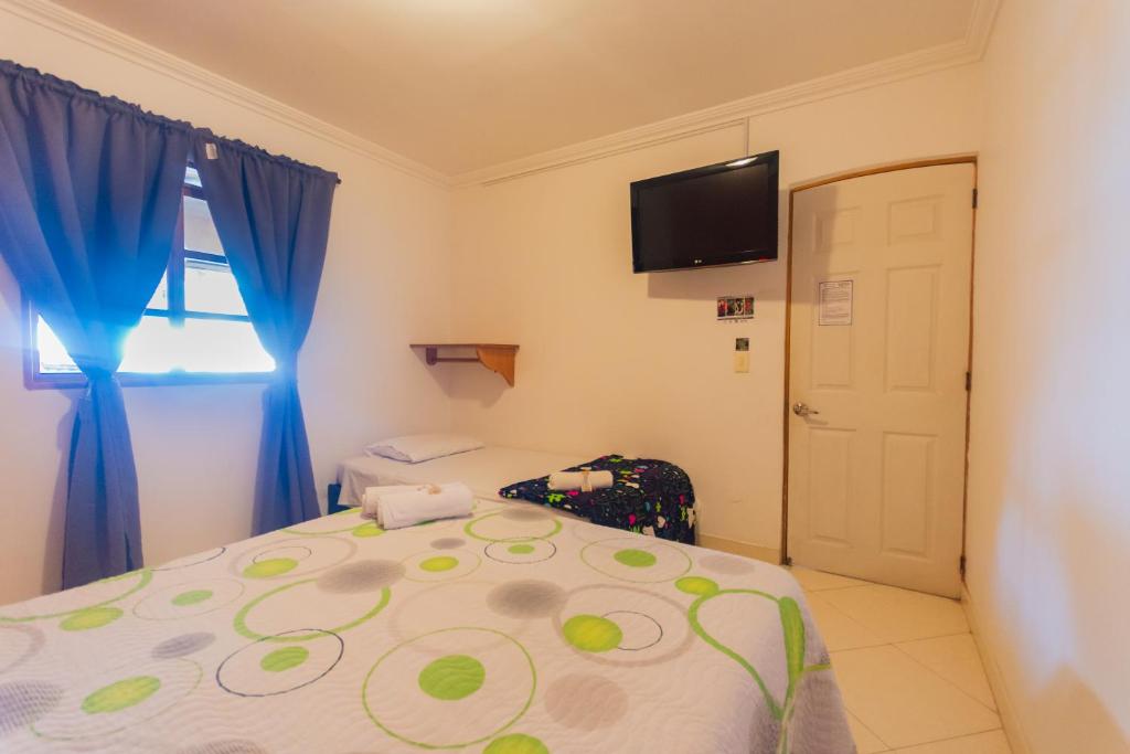 Postel nebo postele na pokoji v ubytování Hotel Real Guatapé