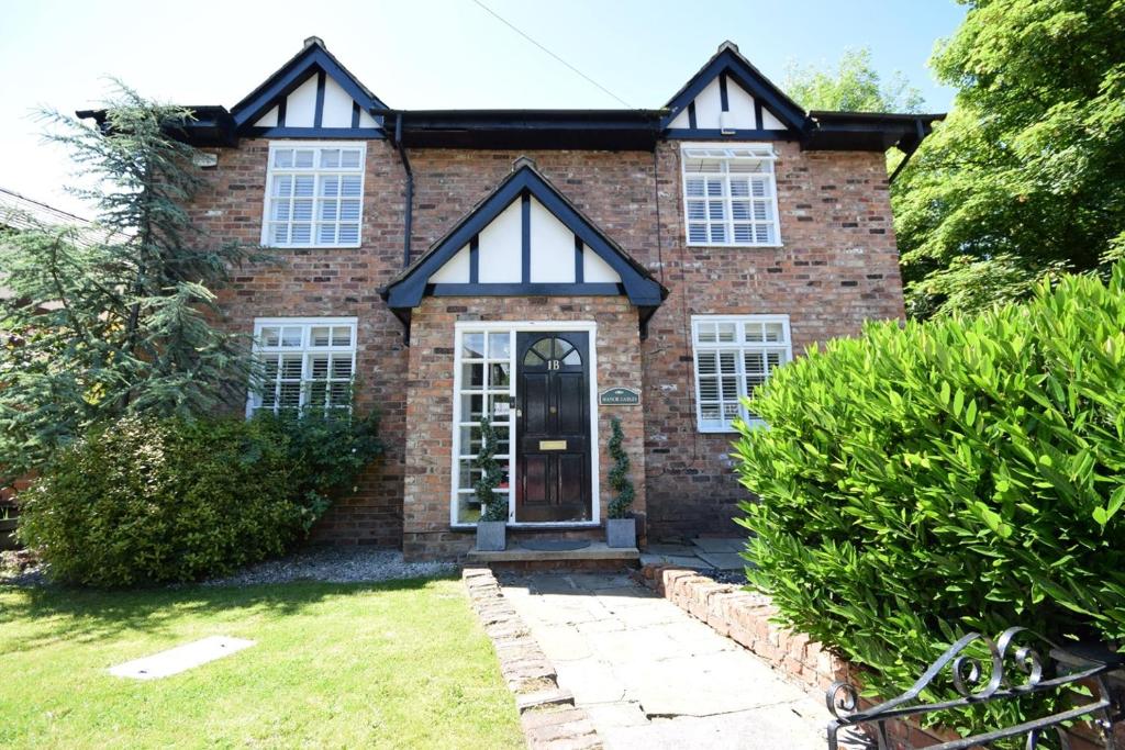 a brick house with white windows and a door at 4 Bedroom, 7 Bed, 2.5 Bath - Detached House in Cheadle