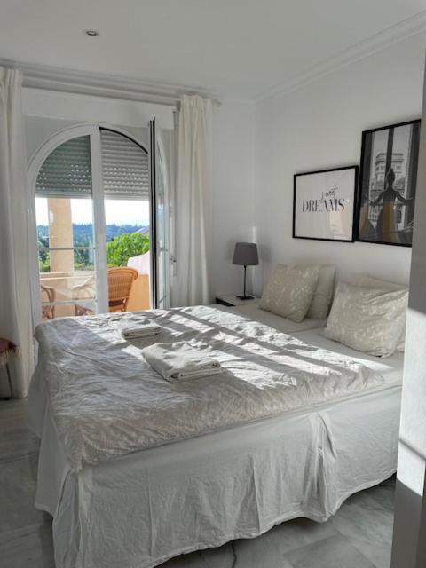A bed or beds in a room at Walking distance to Puerto Banus sea view Apartment