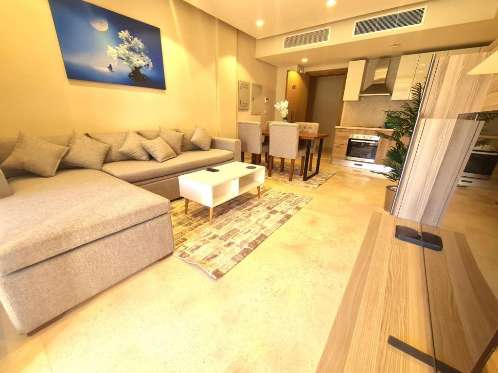 a living room with a couch and a table at Fabulous Sea view 1 BR & private Garden to the pool at Mangroovy in Hurghada