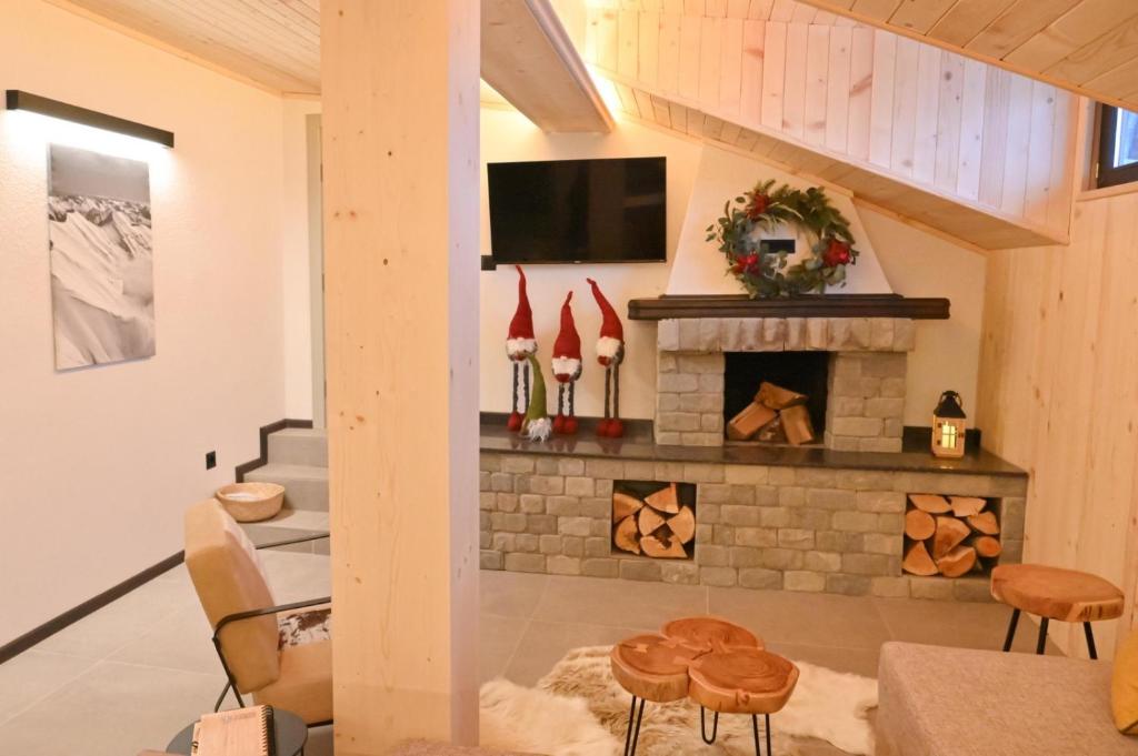 ein Wohnzimmer mit einem Kamin und einem TV in der Unterkunft Marand Boutique Apartments in Bansko
