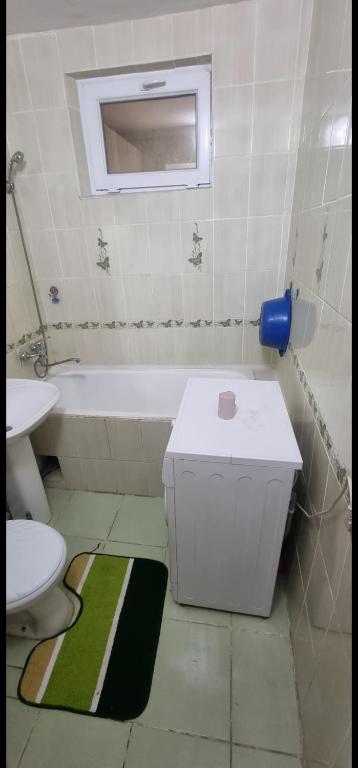a bathroom with a tub and a toilet and a sink at 3 комнатная, айбергенова in Shymkent