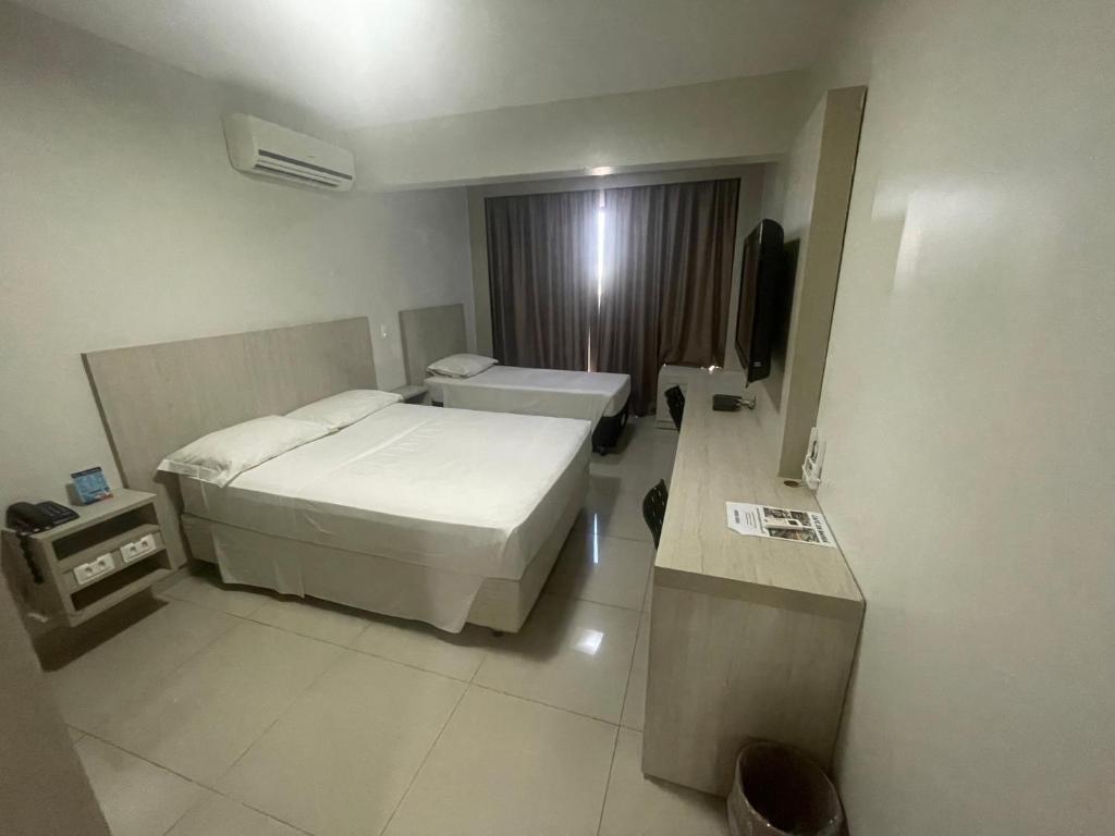 Habitación de hotel con cama y TV en MIX APART Hotel, en Brasilia