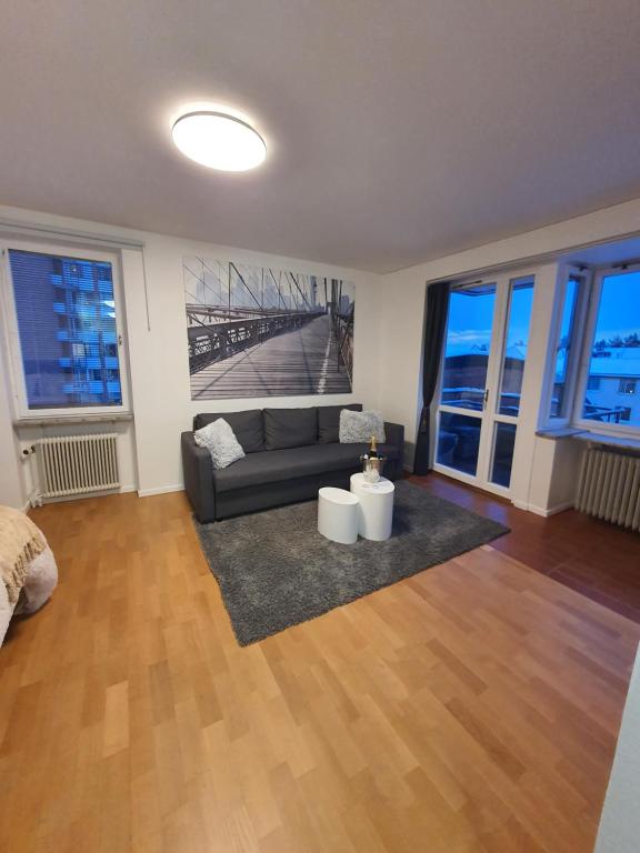 a living room with a couch and a table at Close to the subway. Beautiful and Cozy apartment! in Stockholm