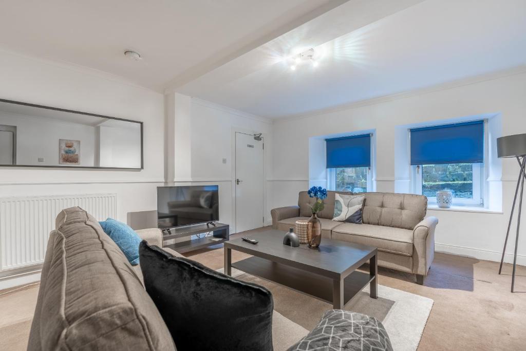 a living room with a couch and a table at The Wilton in Glasgow