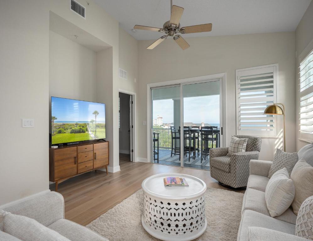 a living room with a couch and a tv at 365 Cinnamon Beach in Palm Coast