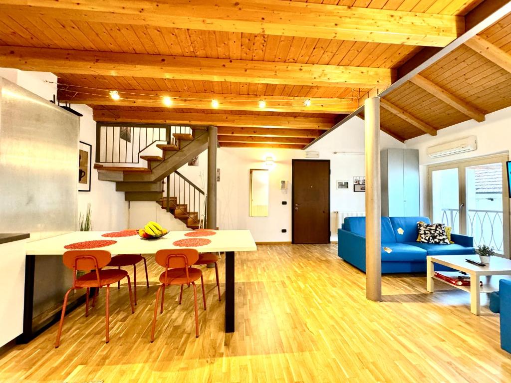 a kitchen and living room with a table and chairs at The Loft in Timişoara