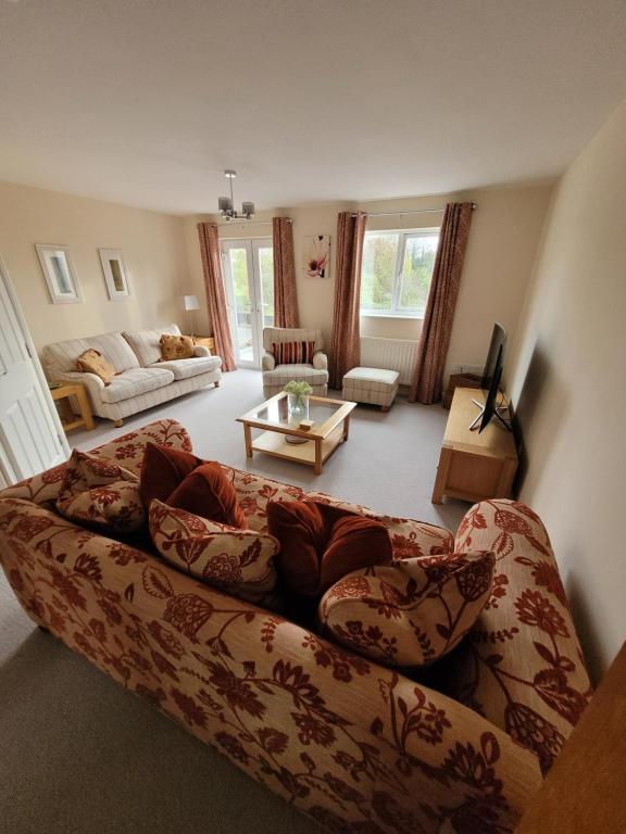 a living room with a couch and a table at Golden Valley View in Codnor