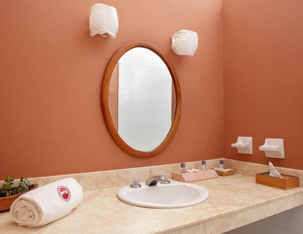 a bathroom with a sink and a mirror at Posada del Campanario in Barichara