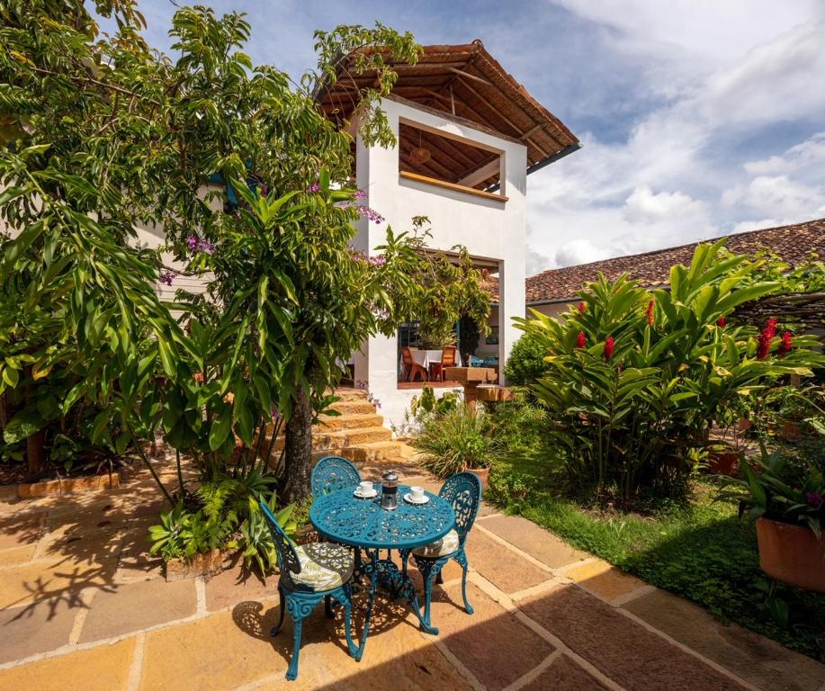 a blue table and chairs in front of a house at Posada del Campanario in Barichara