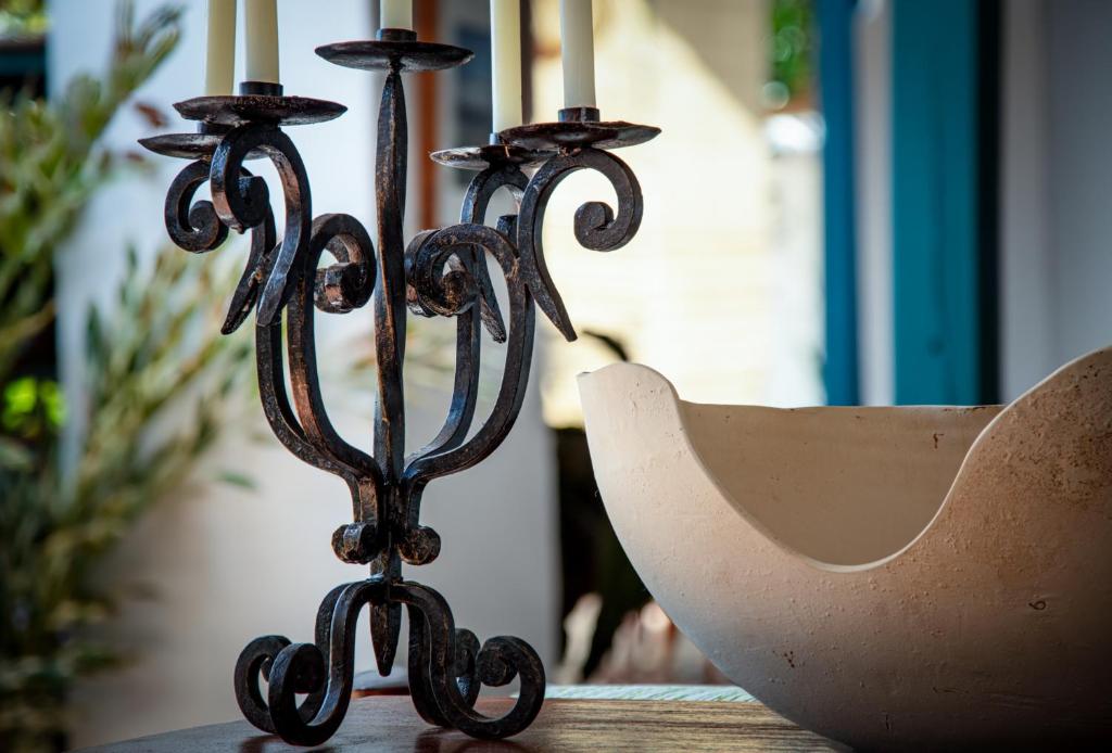 a candle holder sitting on top of a table at Posada del Campanario in Barichara