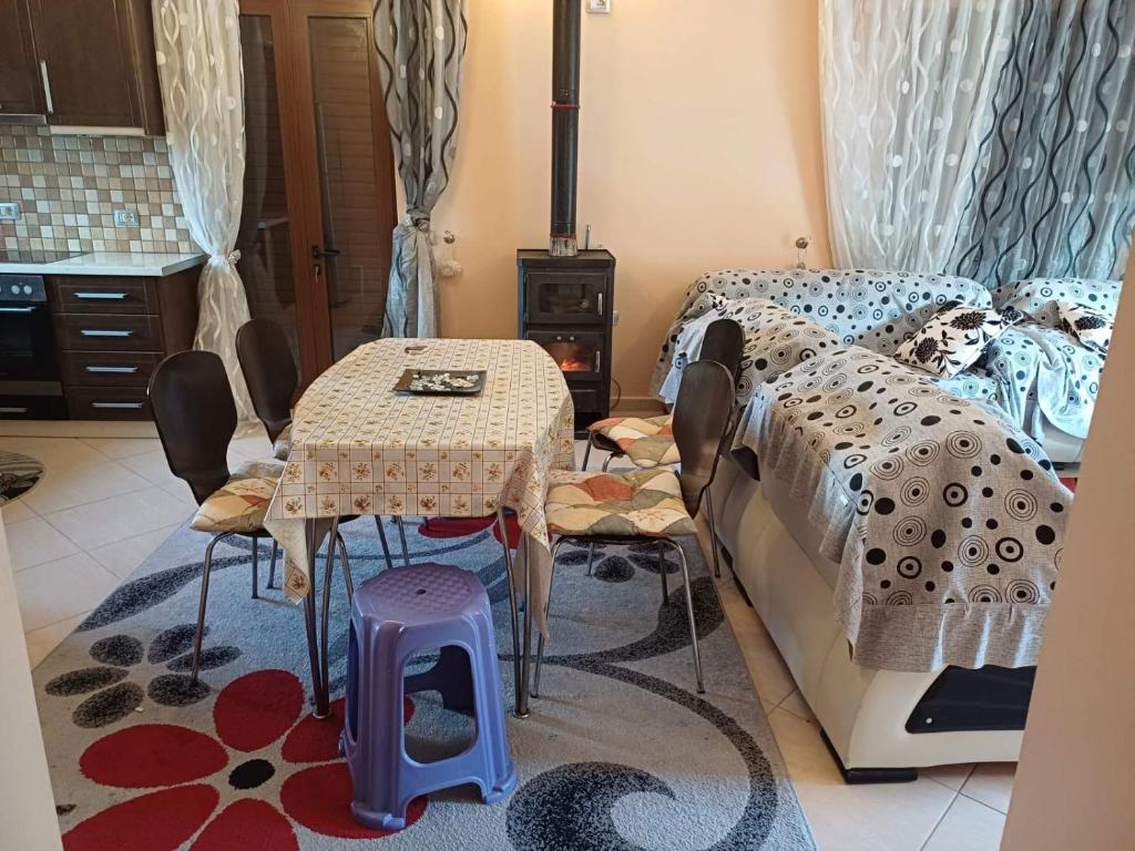 - une chambre avec un lit, une table et des chaises dans l'établissement Leonidas Apartment, à Berat