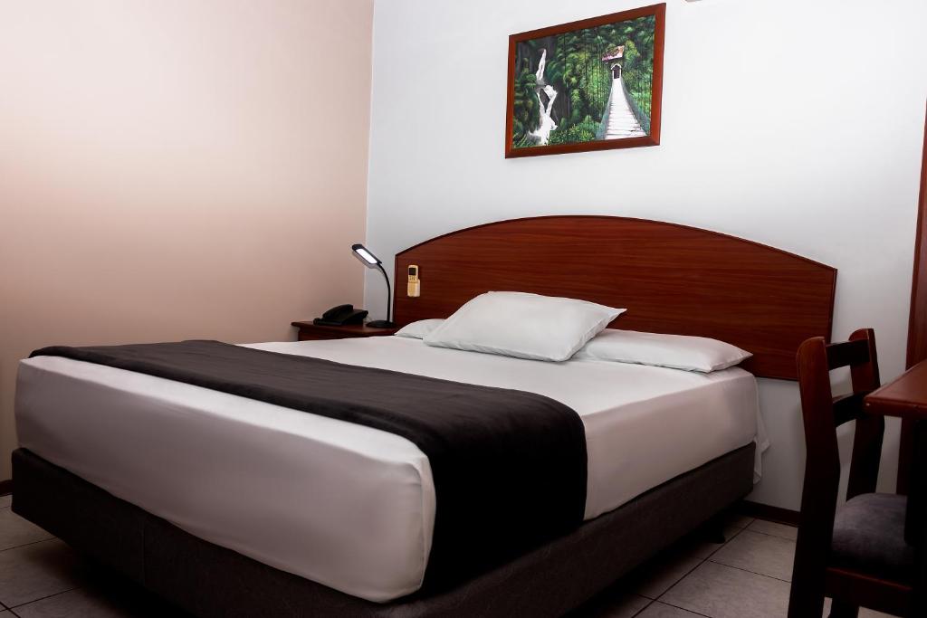 Postel nebo postele na pokoji v ubytování Grand Hotel Machala
