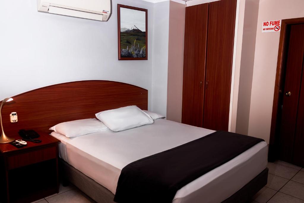 Postel nebo postele na pokoji v ubytování Grand Hotel Machala