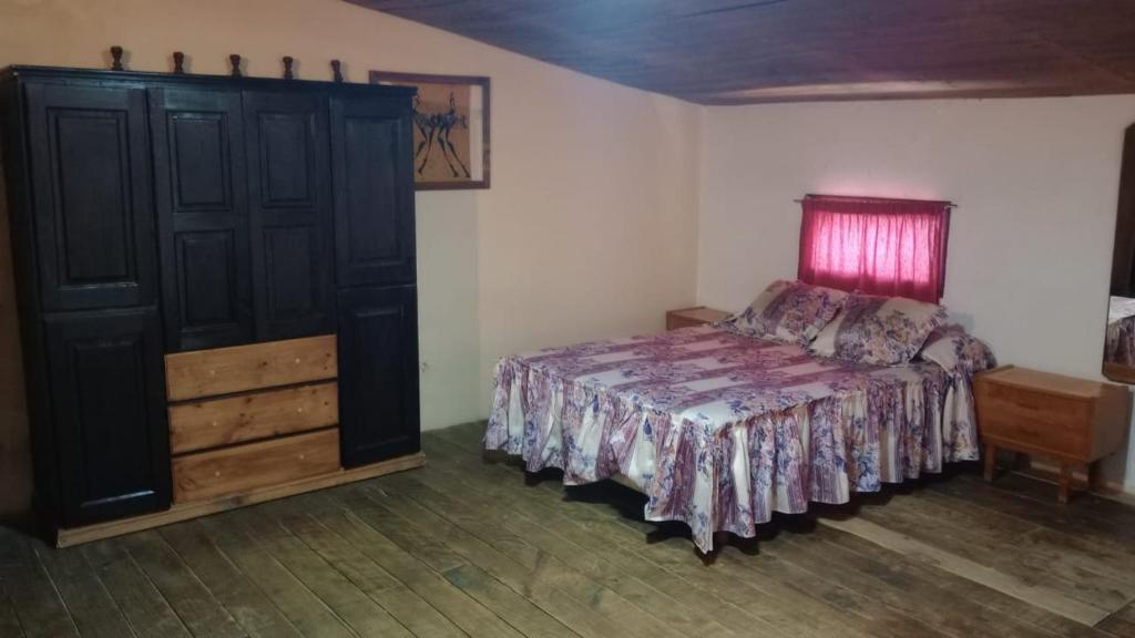 a bedroom with a bed and a dresser at Departamento 4 playa sencillo in Necochea
