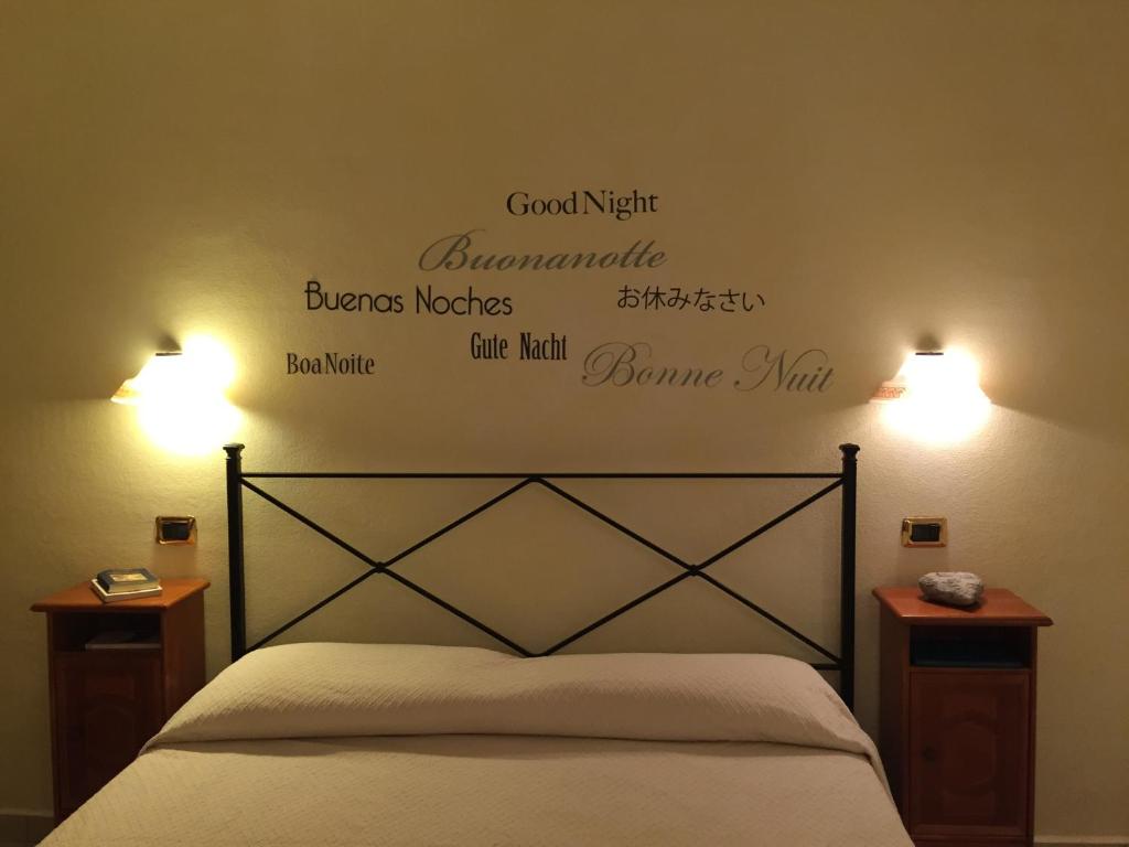 sypialnia z łóżkiem z dwoma światłami na ścianie w obiekcie Borgo dei Conti Holiday Home w mieście Capitana