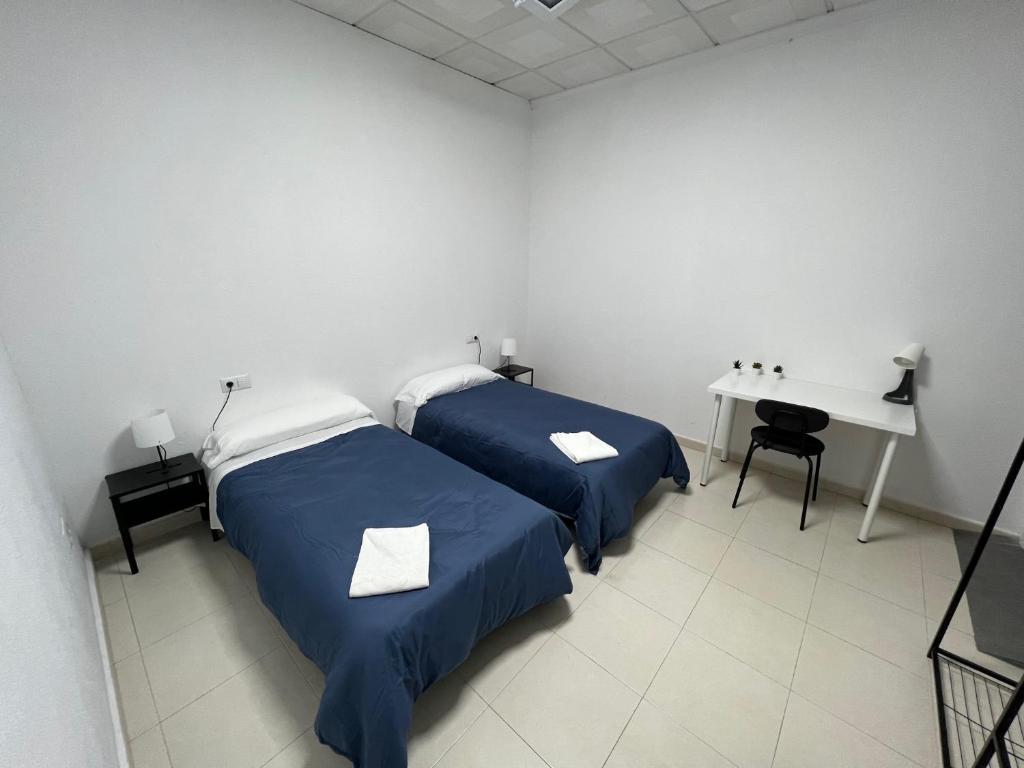 Postel nebo postele na pokoji v ubytování Hostal Kaizen