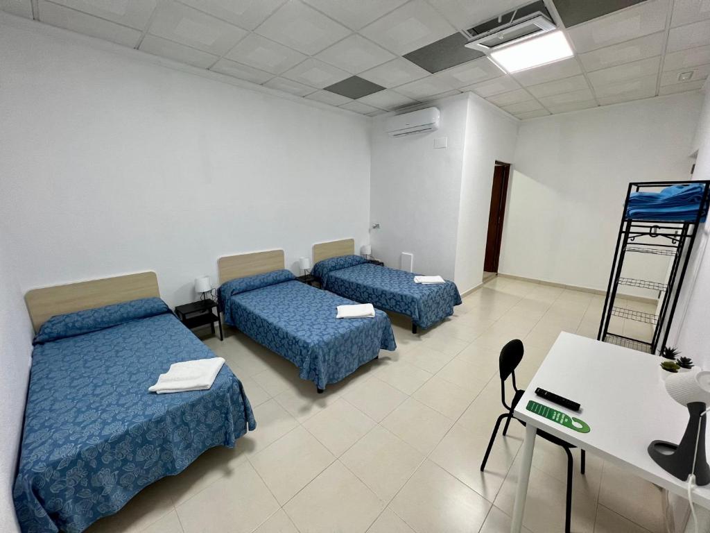 Postel nebo postele na pokoji v ubytování Hostal Kaizen