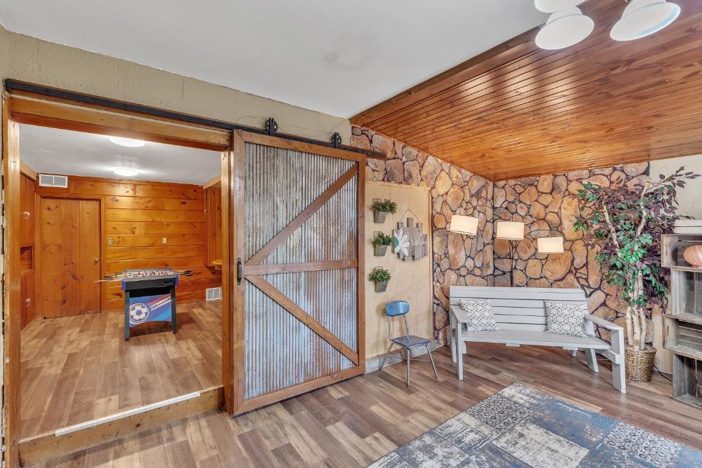 a living room with a barn door and a bench at Downtown 2 story property apts in Spearfish