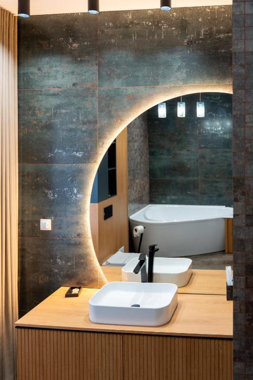 a bathroom with two sinks and a mirror at Wanderer Sighisoara in Sighişoara