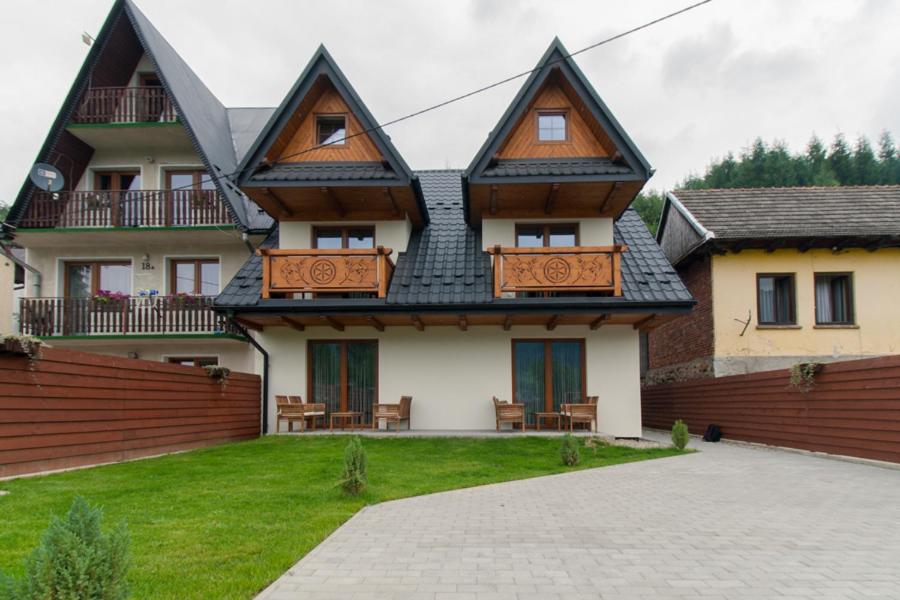 a large house with a fence in front of it at Pod Reglami in Krościenko