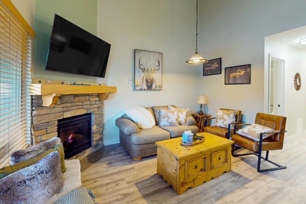a living room with a couch and a fireplace at Stagecoach Ski Condo in Stateline