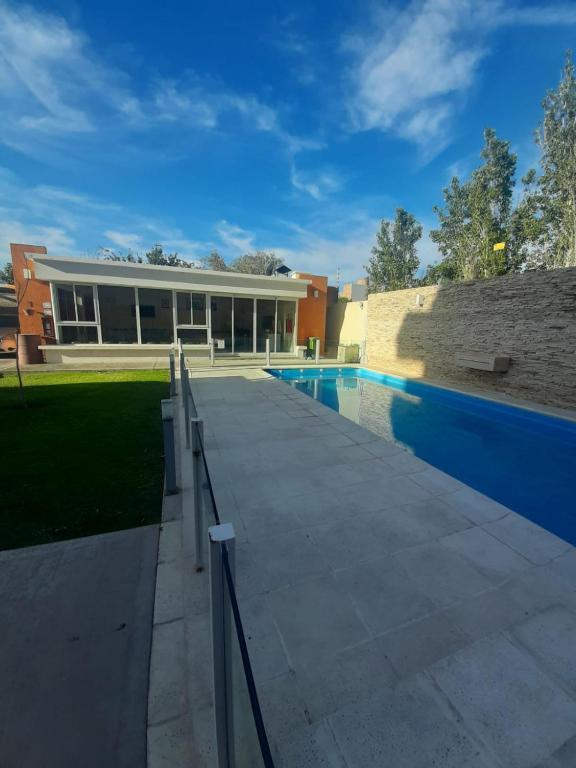 a house with a swimming pool next to a building at Consorcio San Ignacio in San Juan