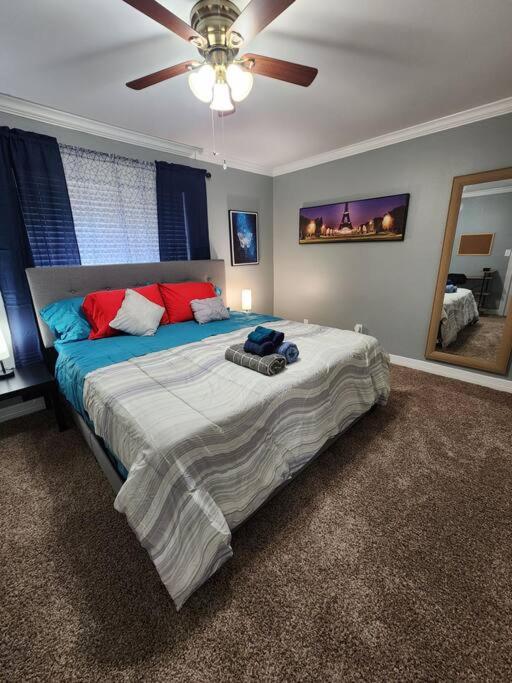 a bedroom with a large bed with a ceiling fan at Blue Shark *E4* @ Midtown Comfortable 1BR King Apartment in Houston