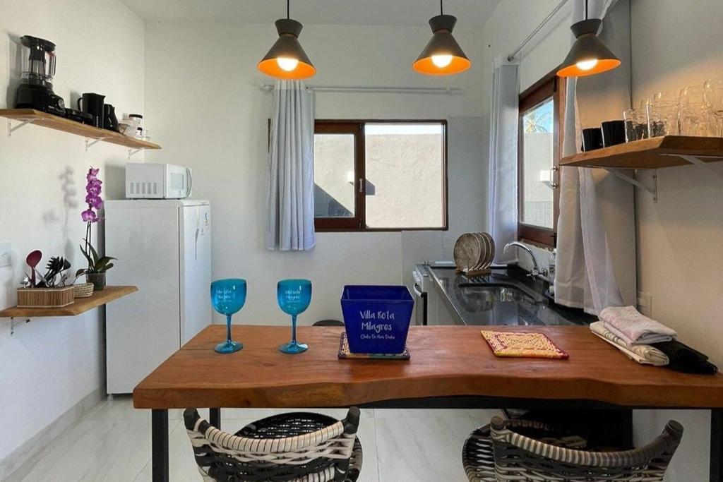 a kitchen with a table and two glasses on it at Suíte villa rota milagres, aconchegante & completa in São Miguel dos Milagres
