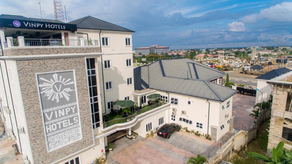 a hotel with a sign on the side of a building at Vinpy hotels in Uyo