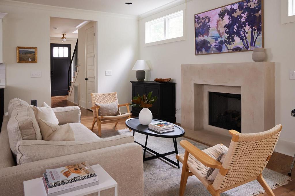 a living room with a couch and a fireplace at The Wendell House - Idyllic Designer Escape in Nashville