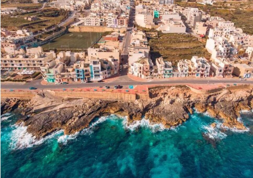 an aerial view of a city and the ocean at SeaWaves Apartments in Xgħajra